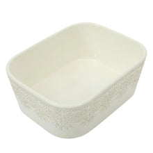 Cream lace-pattern square baking dish with smooth interior, no lid
