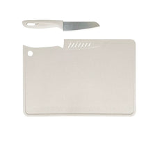 White cutting board with handle hole and attached knife for slicing
