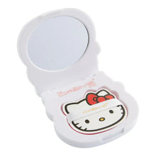 Open Hello Kitty compact mirror with circular mirror and blotting paper pad insert