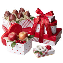 Fruit gift tower with red bows, apples and pears in heart-patterned boxes