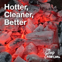 Lump charcoal pieces glowing in red heat inside a grill