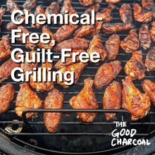 Grill with glowing embers and roasted chicken over burning lump charcoal