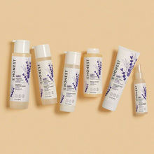 Set of Honest lavender baby shampoo and body wash bottles, assorted sizes