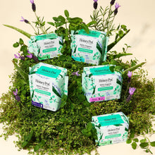 Multiple packs of herbal super pads with wings and organic cotton cover, 16 count