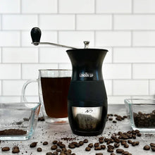 London Sip manual coffee grinder, black body with side handle and grind window