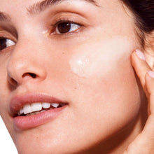 Face serum sheen on cheek with a small dab near the eye