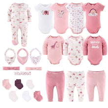 Baby layette set with pink and white safari bodysuits, pants, socks, and headband