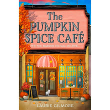 Paperback novel with illustrated pumpkin spice cafe storefront cover.