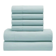 Peached percale sheet set, light blue folded sheets stack with edges visible