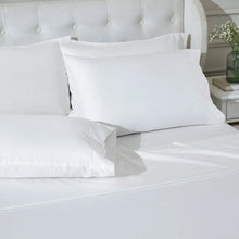 White sheet set with pillowcases and flat sheet on bed