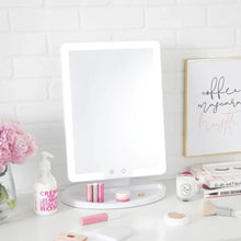 Lighted makeup mirror with bright LED panel on round base, on vanity counter