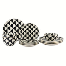 Ceramic dinnerware set with black-and-white geometric patterned plates and bowls