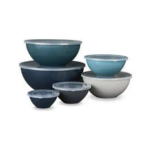 Blue nesting mixing bowls set with clear lids, stacked in varying sizes