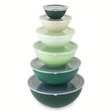 Nesting mixing bowl set with lids, assorted green bowls stacked together