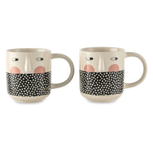 Stoneware cheeky face mug with black polka-dot band, blush nose, and curved handle