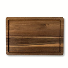 Acacia wood cutting board with rectangular recessed grip area and visible wood grain