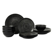 Stoneware dinnerware set with black radial-pattern plates, bowls, and cups