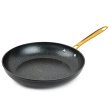 Black non-stick fry pan with gold handle and speckled interior.