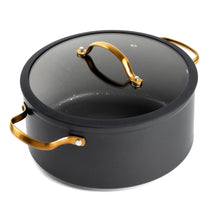Black non-stick stock pot with glass lid and gold-tone handles