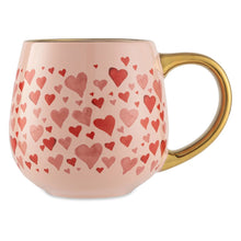 Pink ceramic mug with red heart pattern and gold-tone handle, 16 fl oz.