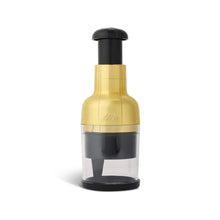 Gold and black veggie chopper with clear container and black press top, stainless blade