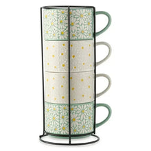 White and green floral stacking mugs set on black wire rack, side view