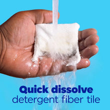 Foamy hands holding a white detergent fiber tile dissolving in water