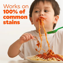 Laundry detergent pacs concept with toddler eating spaghetti and sauce on shirt
