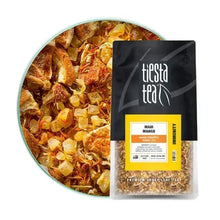 Loose leaf herbal tea bag labeled Maui Mango, beside a bowl of loose tea pieces.