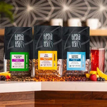 Loose leaf herbal tea variety pack, three sealed tea bags with colorful label panels.