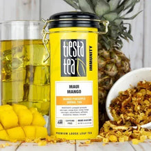 Maui Mango herbal loose leaf tea tin with swing-top lid and scattered tea