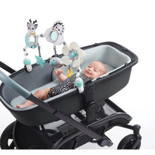 Infant in stroller with overhead toy arch, cow, hedgehog, flower, star and fish hangers