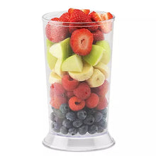 Blender smoothie cup with fruit pieces inside, clear plastic