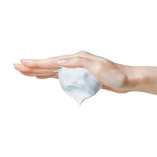 Hand holding white cleansing foam drop and swirl