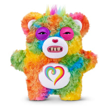 Rainbow fuzzy monster plush with purple eyes, open mouth and heart emblem chest