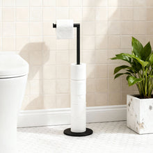 Black free-standing toilet paper holder stand with one roll and spare rolls stacked