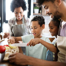 Family cooking and serving a chicken and tomato flavored dish