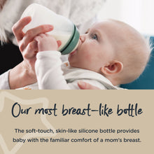 Tommee Tippee breast-like baby bottle with teal cap as baby drinks