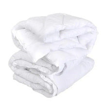 White down-alternative comforter folded and bundled, quilted channel design visible