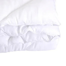 White down-alternative comforter layered close-up showing stitched baffles and seams