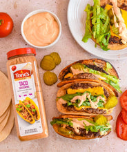 Tone's Taco Seasoning bottle beside tacos with lettuce and sauce