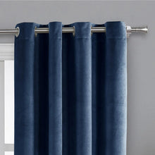 Dark blue velvet blackout curtain panels with top grommets on metal rod