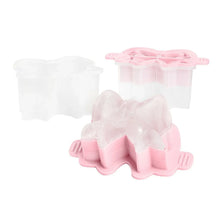 Silicone holiday bow ice molds releasing clear bow-shaped ice, pink base and cavities