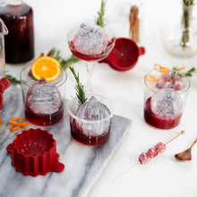 Ice ornament molds on a tray: three clear domes and one red silicone mold base