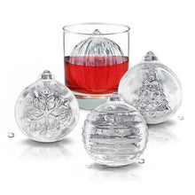 Four clear ice ornament molds with textured surfaces and a red liquid-filled centerpiece