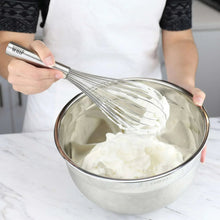 Stainless steel whisk over a metal bowl with pale cream batter, 6-piece set.