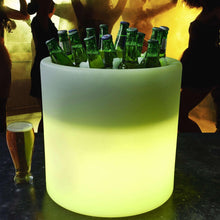 LED beverage tub with green glow, partially filled with bottles