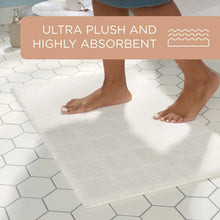 White ultra plush bath mat with tufted square pattern underfoot