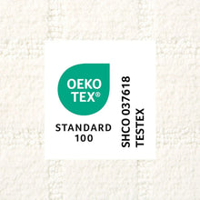 White bath mat showing OEKO-TEX Standard 100 label