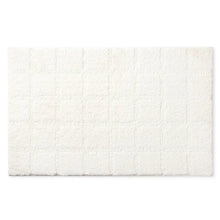 White plush rectangular bath mat with subtle tufted square pattern